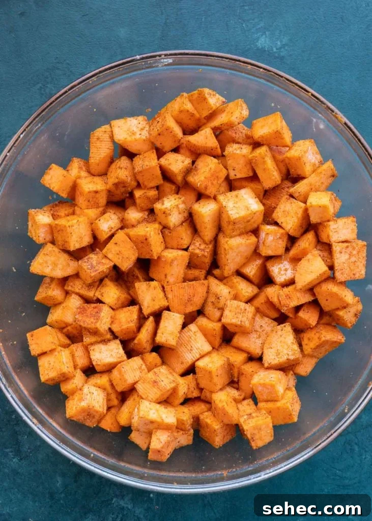 Crispy Air Fryer Sweet Potato Cubes 8 seasoned sweet potato cubes in a bowl