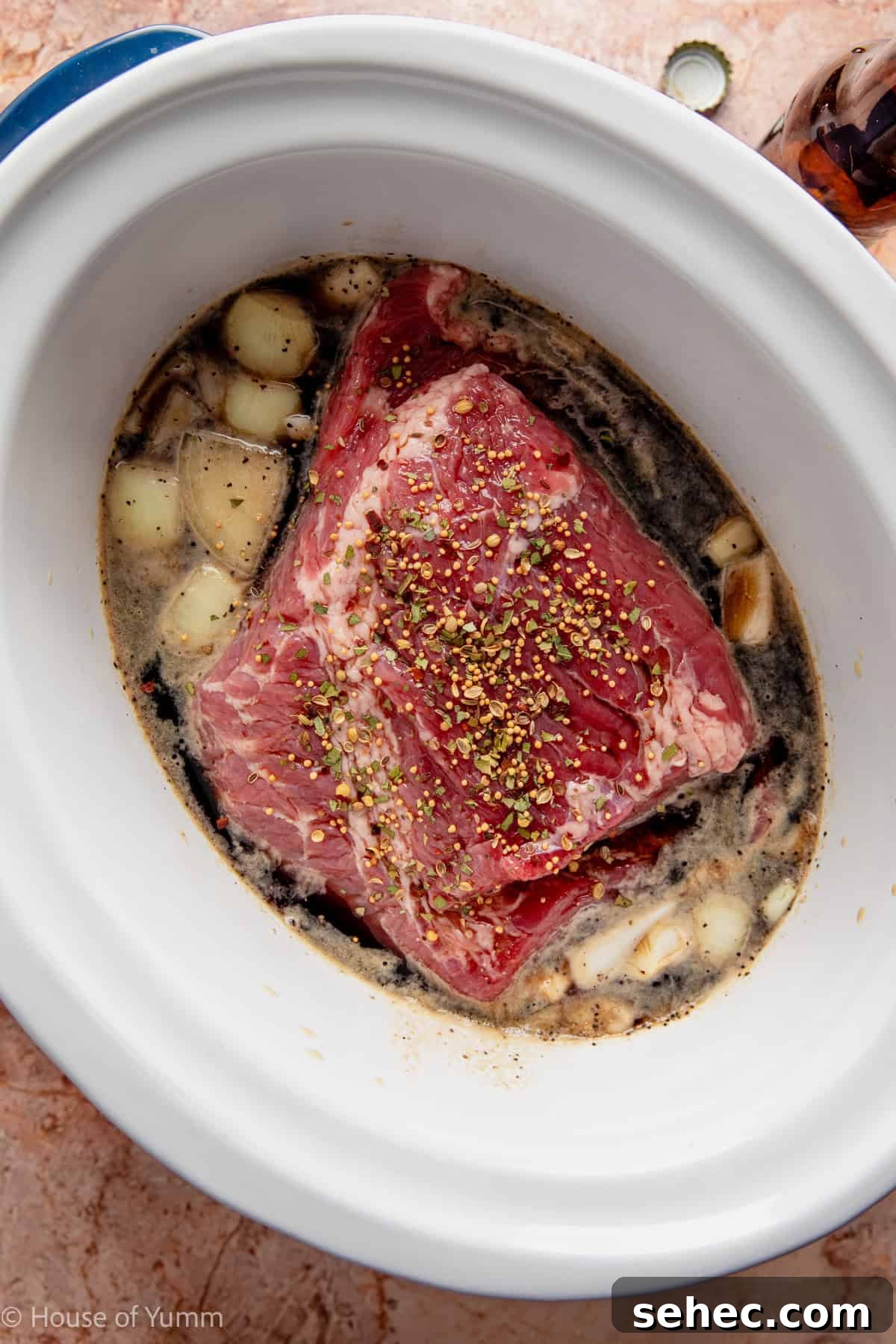 Slow Cooker Corned Beef Recipe for Tender Slices 6 corned beef added to a slow cooker with seasonings, broth, and guiness beer.