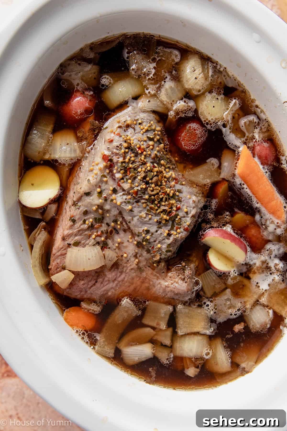 Slow Cooker Corned Beef Recipe for Tender Slices 7 Corned beef cooked in slow cooker partway and adding potato and carrots.