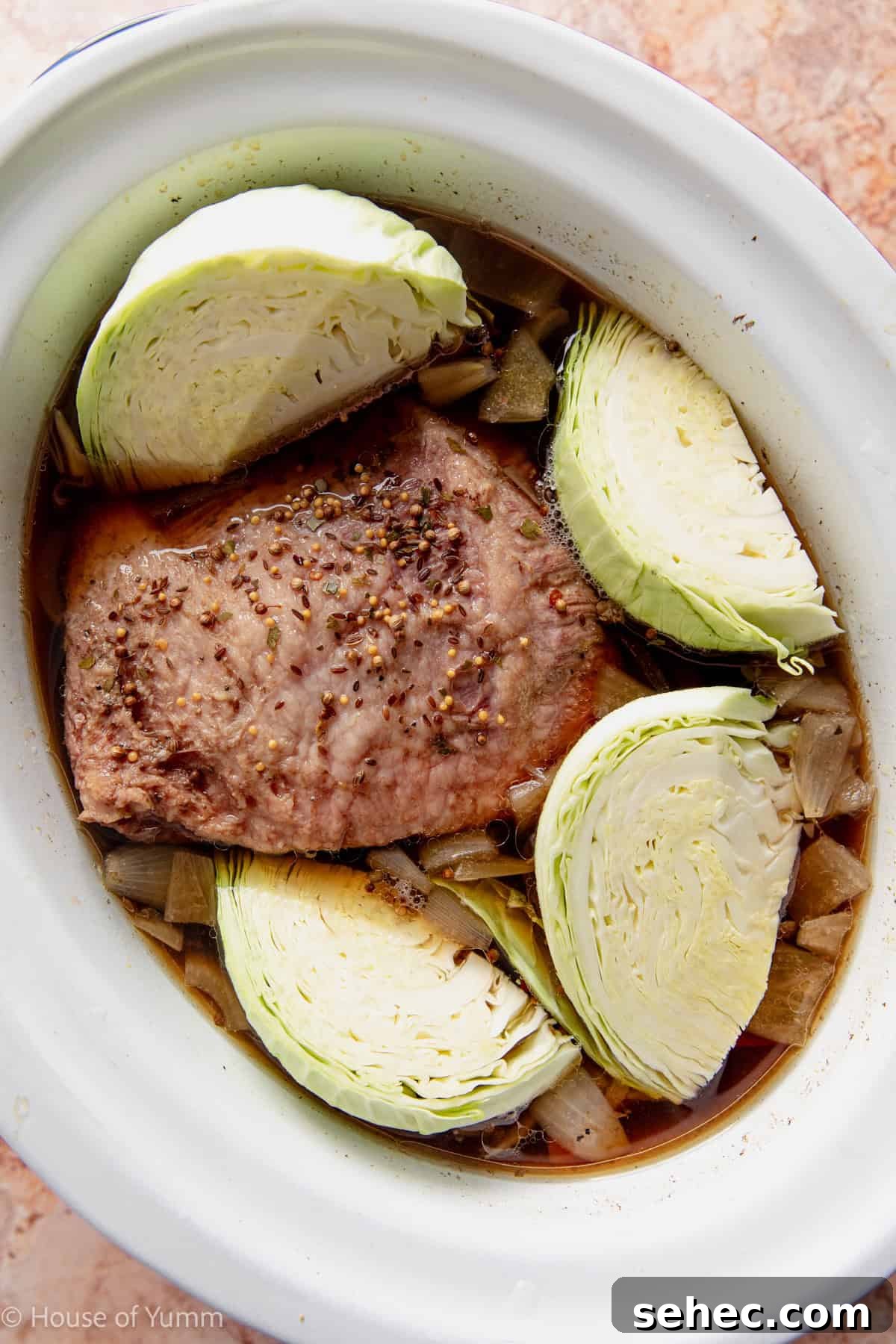 Slow Cooker Corned Beef Recipe for Tender Slices 8 Cabbage added to a corned beef cooking in a slow cooker.