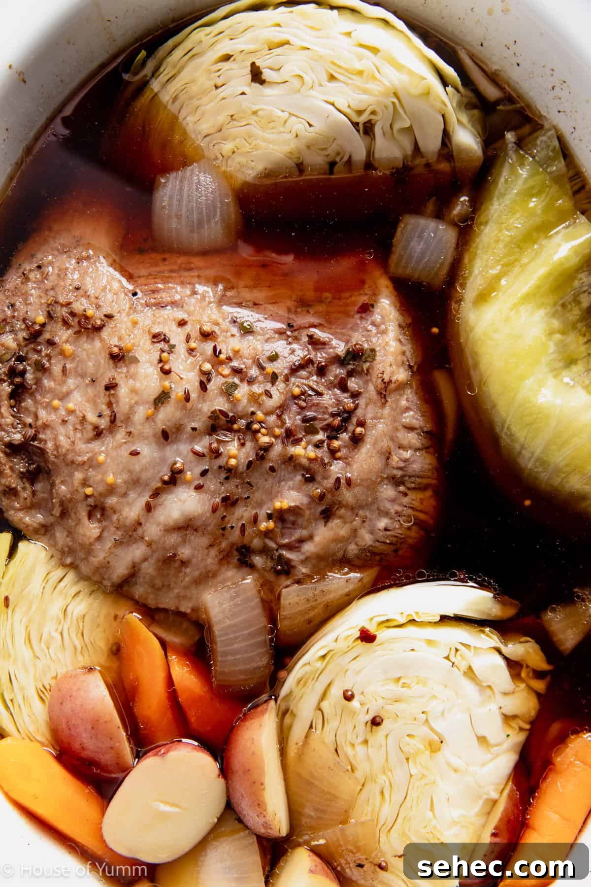 Slow Cooker Corned Beef Recipe for Tender Slices 9 Corned beef cooked in a slow cooker with potatoes, carrots, and cabbage.