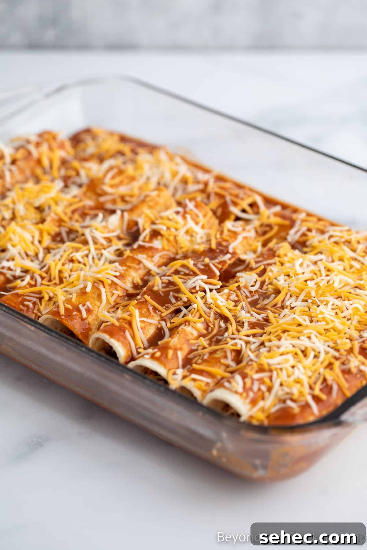 Ground Turkey Enchiladas Recipe 11 Enchiladas in a baking dish.