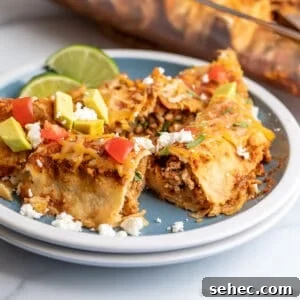 Ground Turkey Enchiladas Recipe 13 Enchiladas cut in half on a blue plate.