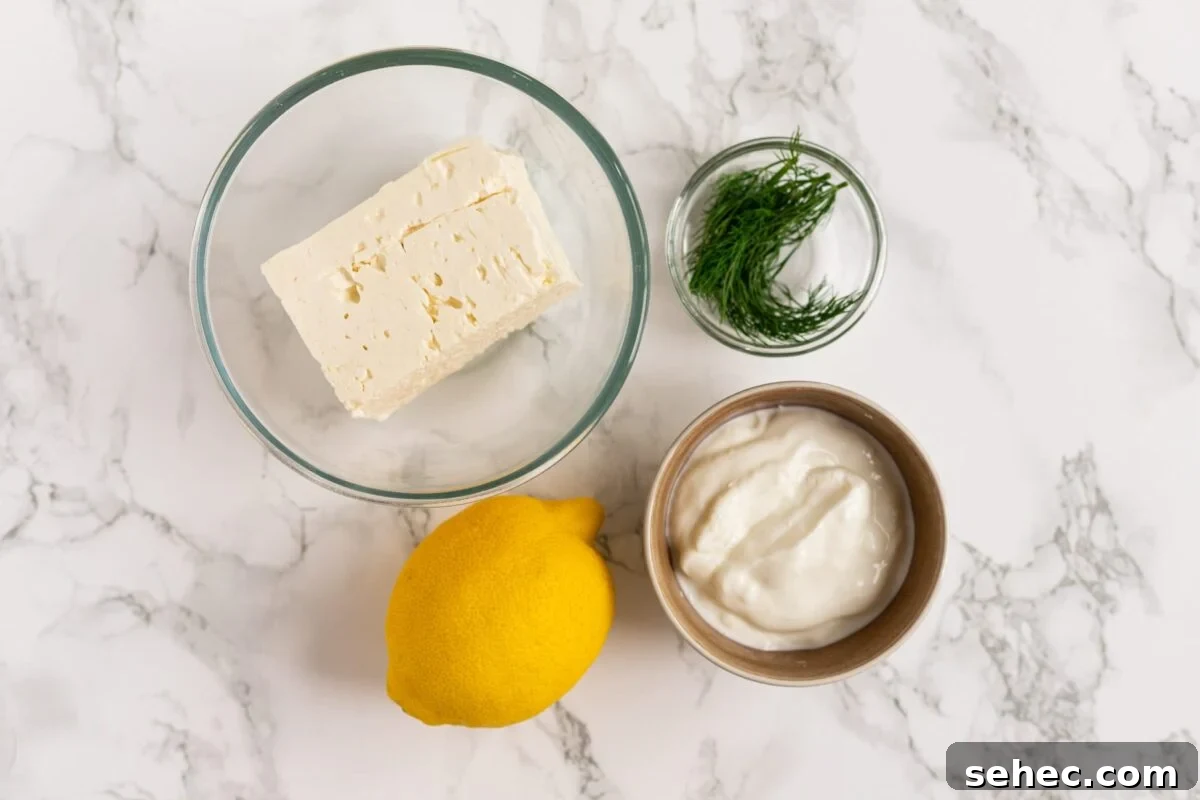 Creamy Whipped Feta Dip with Honey and Herbs 3 Whipped feta ingredients on a marble counter.