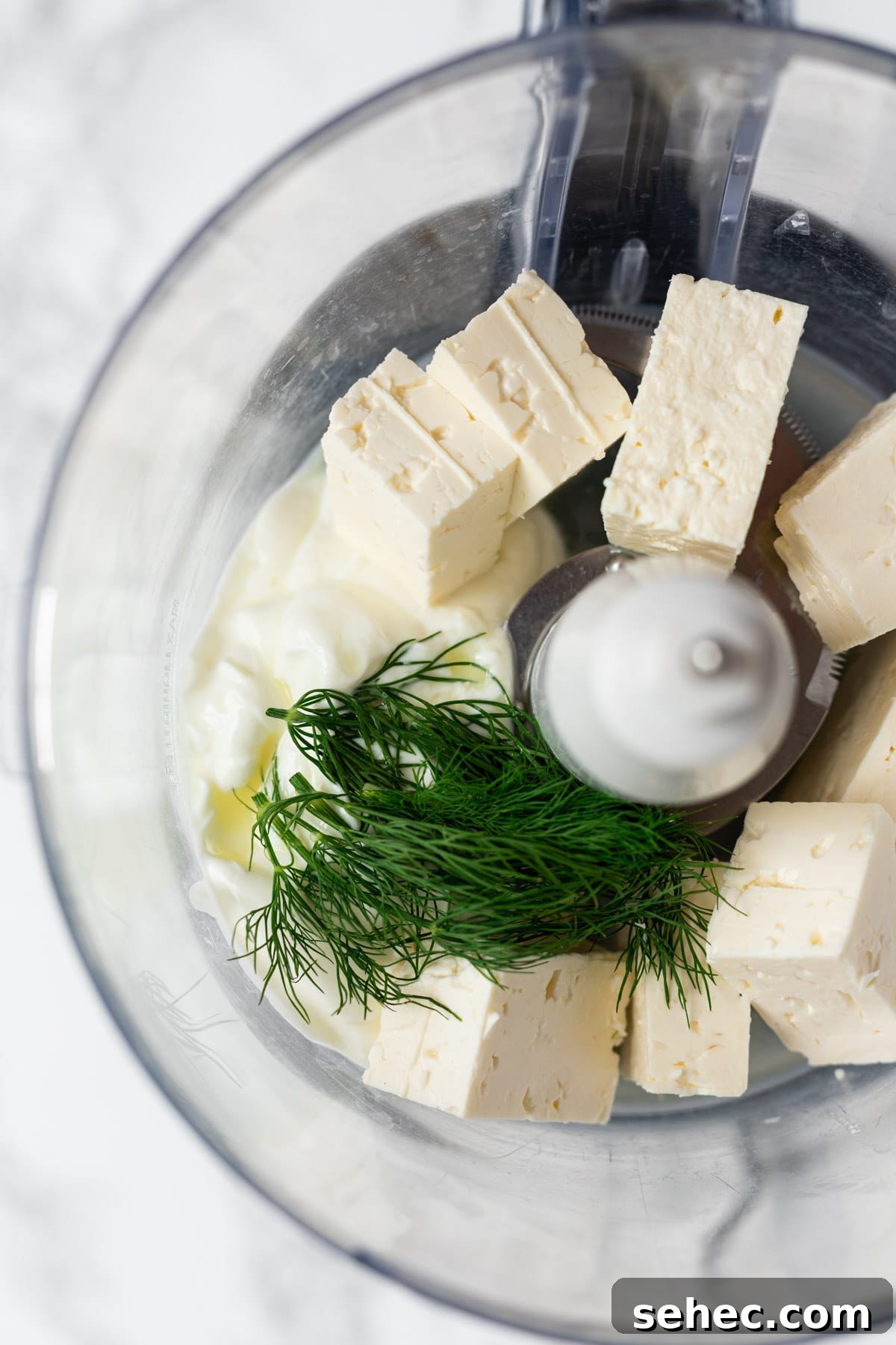Creamy Whipped Feta Dip with Honey and Herbs 4 Whipped feta ingredients in a food processor.