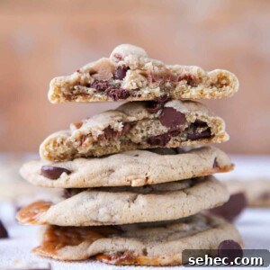 Brown Butter Snickers Cookies Stuffed With Caramel 6 Caramel Stuffed Brown Butter Snickers Chocolate Chip Cookies stacked interior detail.