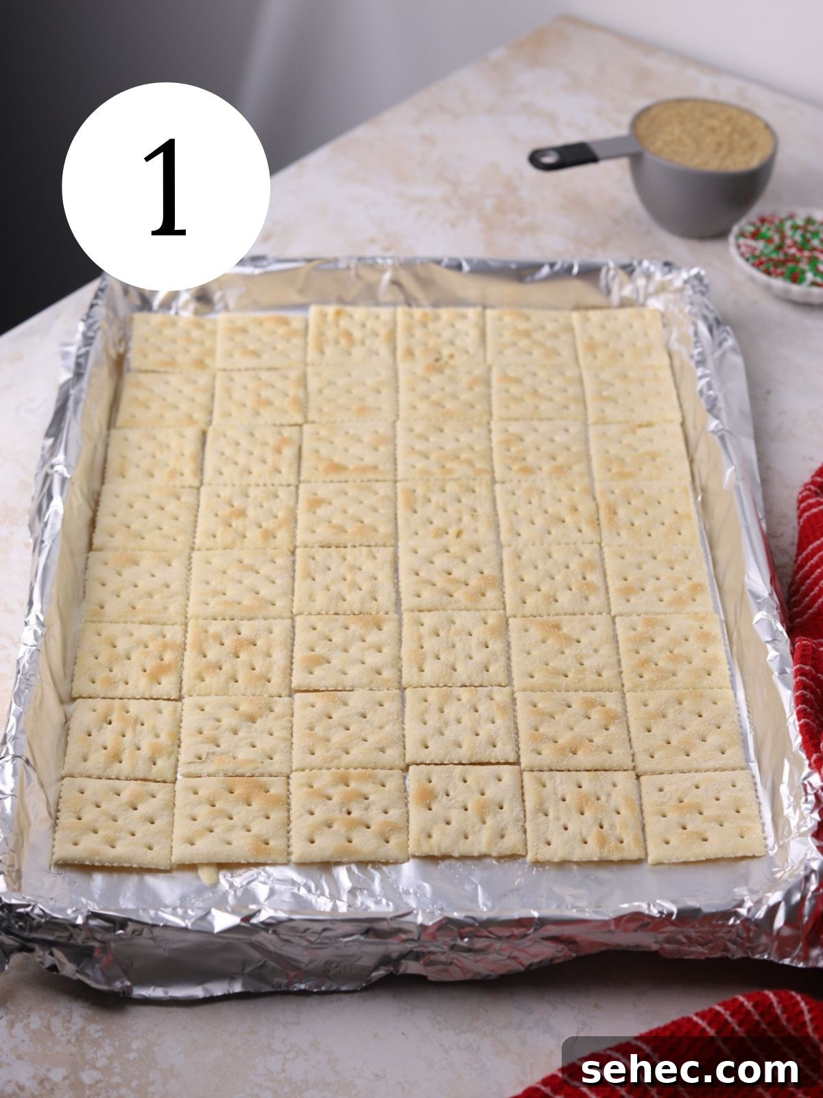 Christmas Crack Saltine Cracker Toffee Recipe 4 Saltine crackers arranged on a foil-lined baking sheet