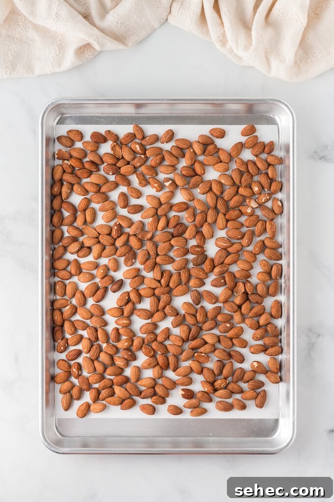 Honey Roasted Almonds Recipe 9 Almonds on a parchment-lined baking sheet