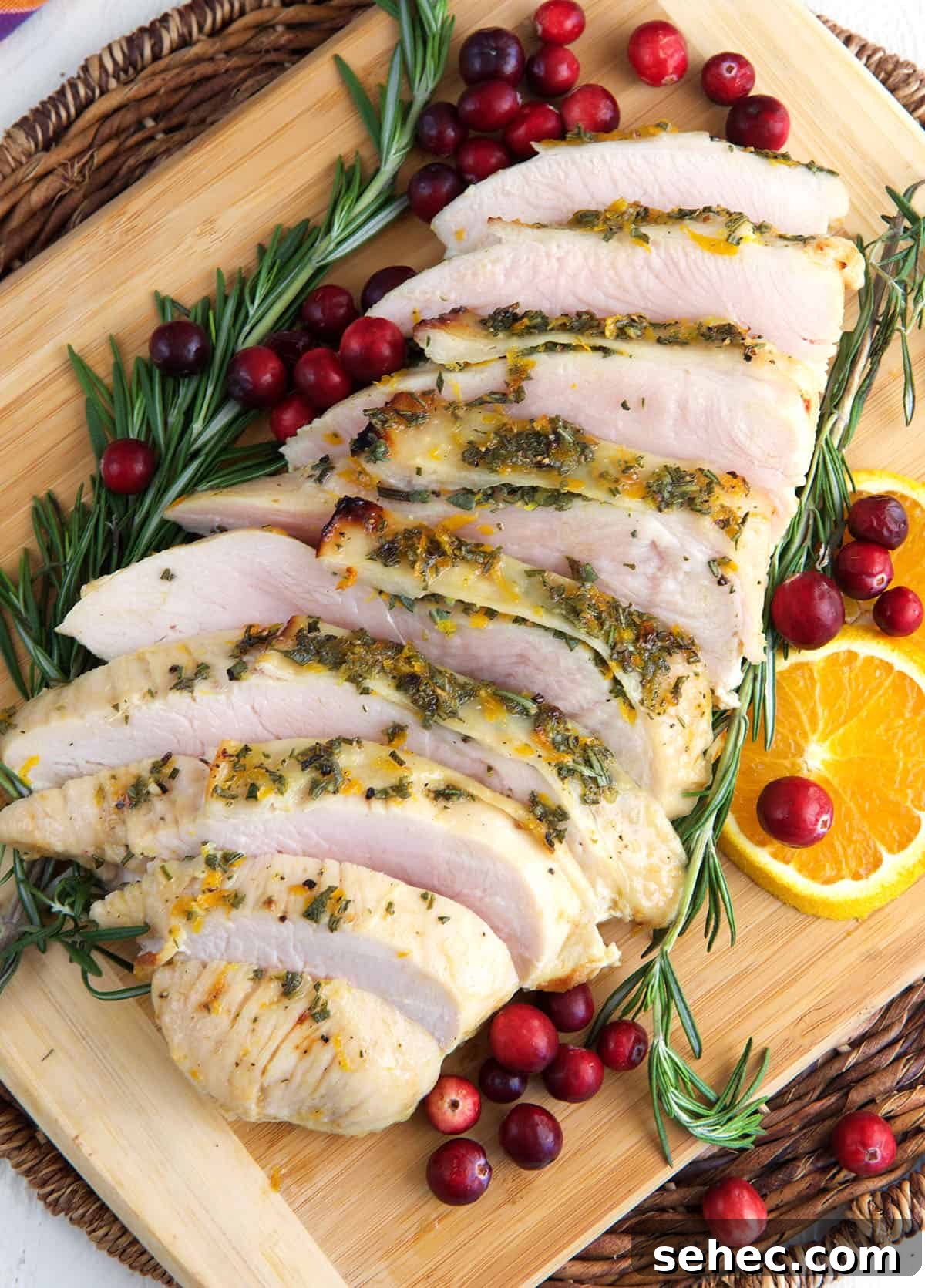 Roasted Turkey Breast with Honey Butter Glaze 2 A sliced turkey breast is presented with rosemary and cranberries.