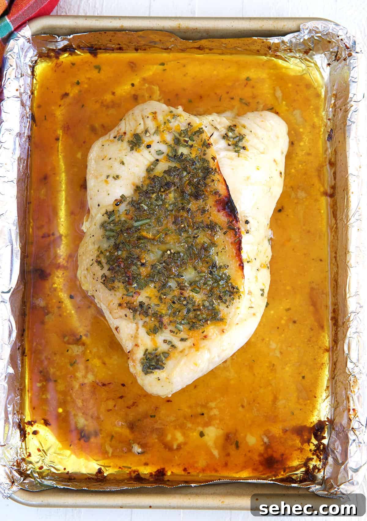 Roasted Turkey Breast with Honey Butter Glaze 3 A roasted turkey breast is placed on a baking sheet.