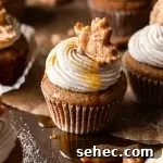 frosted maple cupcakes decorated with leaf shaped pie crust on tabletop