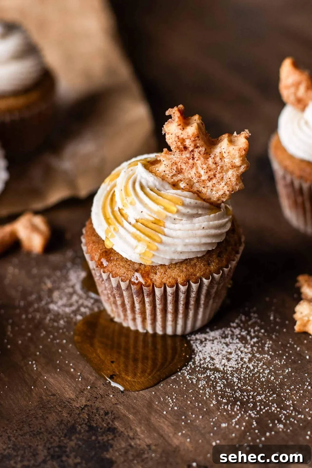 Maple Chai Spice Cupcakes 9 frosted maple cupcakes decorated with leaf shaped pie crust on tabletop