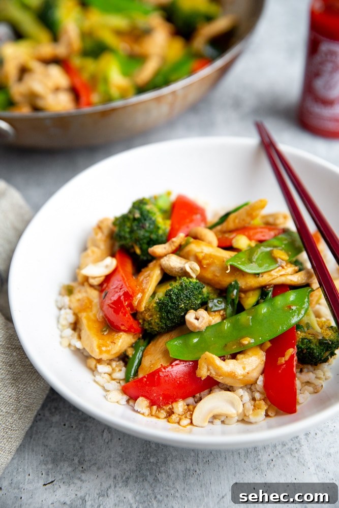 Stir Fry Recipe with Any Vegetables and Meat 10 Healthy stir fry over brown rice in a bowl, with chopsticks alongside.