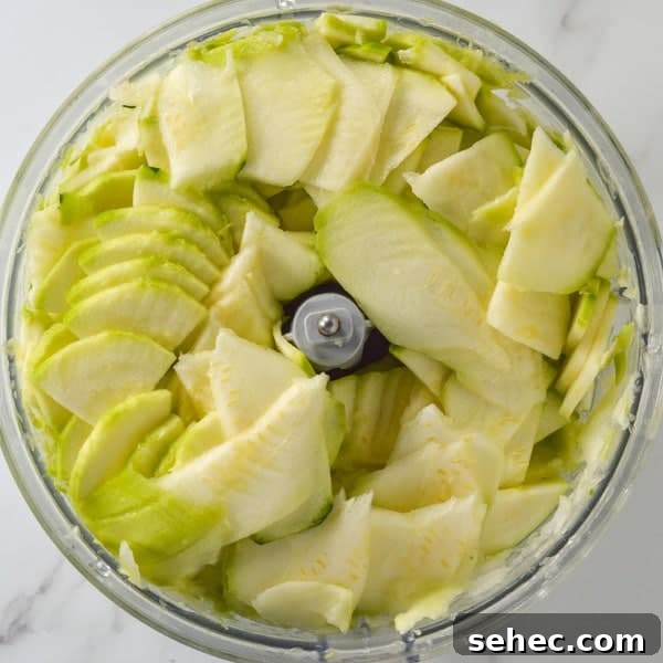 Zucchini Marinara Recipe 4 Zucchini in a food processor that has been sliced thinly
