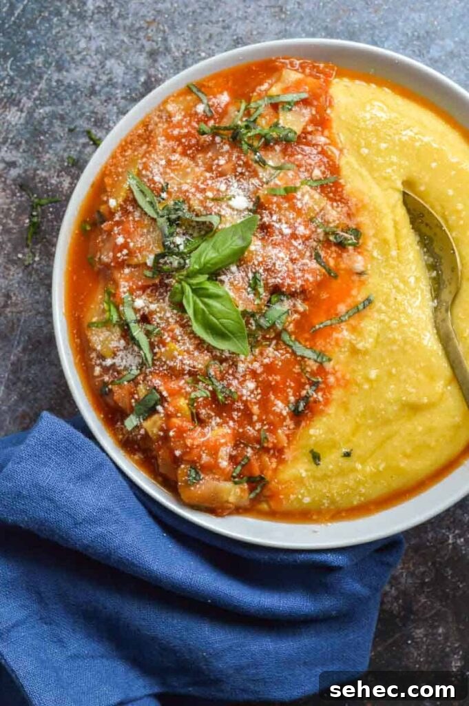 Zucchini Marinara Recipe 8 A grey bowl with marinara dish of zucchini next to a blue serving towel on a table