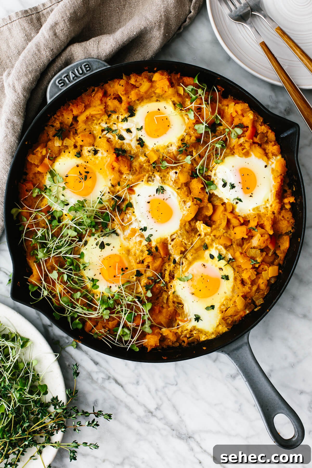 Butternut Squash Recipes for Soups, Sides, and Mains 2 Orange shakshuka in a skillet on a table.
