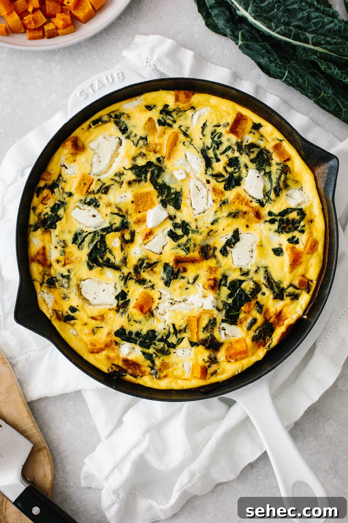Butternut Squash Recipes for Soups, Sides, and Mains 6 Butternut squash frittata in a white saute pan on a table.