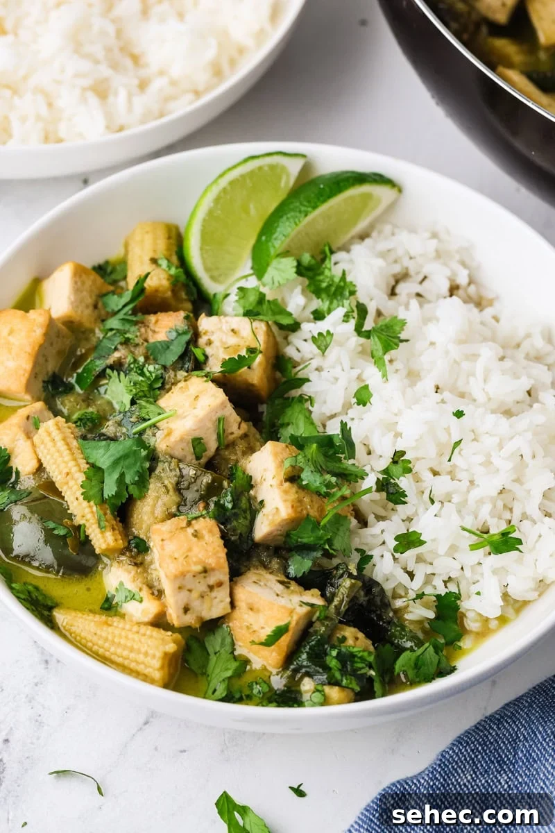 Thai Green Tofu Curry Recipe 2 Thai green curry with tofu served with jasmine rice on a plate.