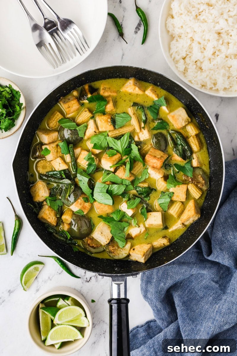 Thai Green Tofu Curry Recipe 12 Thai green curry with tofu garnished with Thai basil leaves and ready to serve.