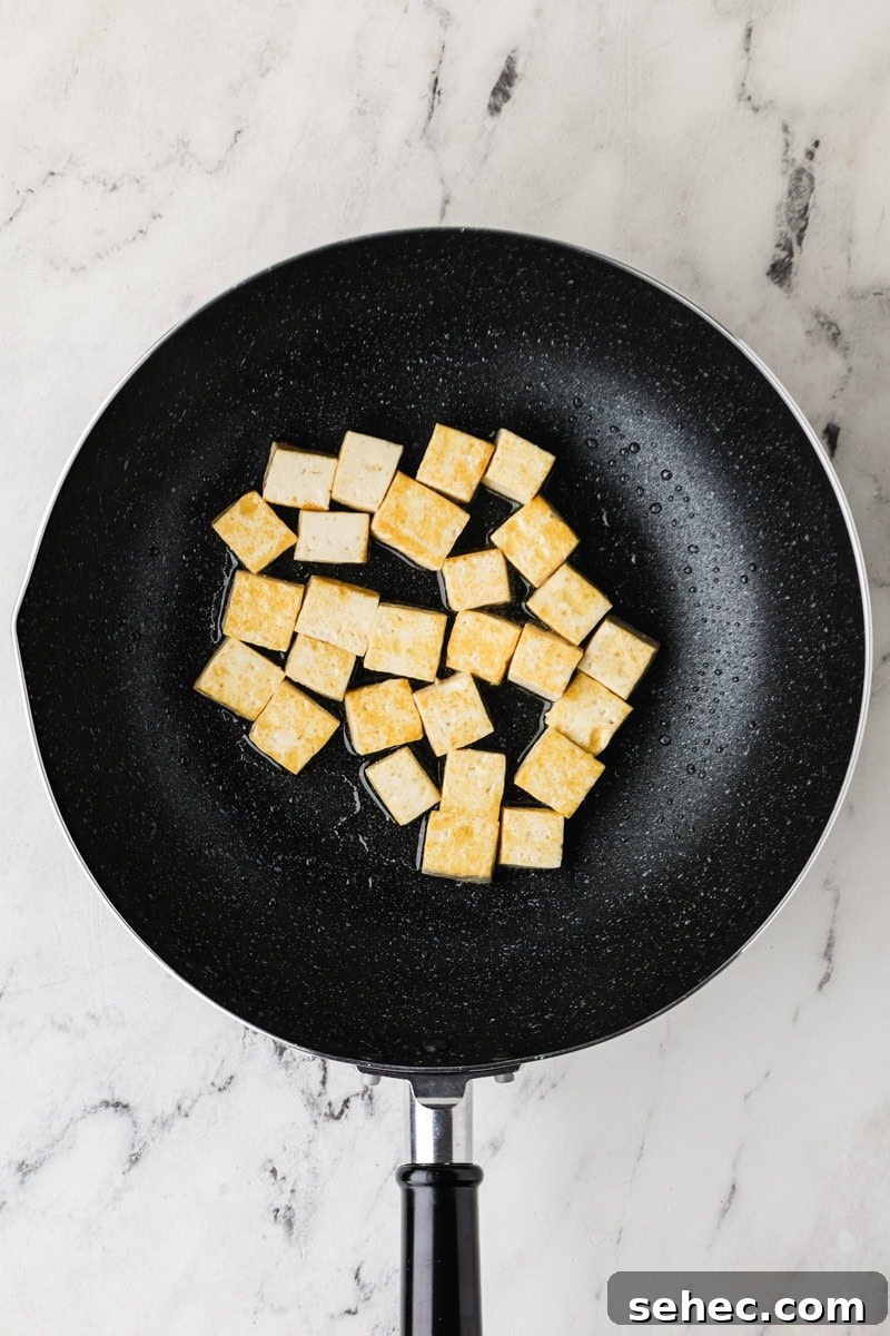 Thai Green Tofu Curry Recipe 7 Tofu being fried in a pan.
