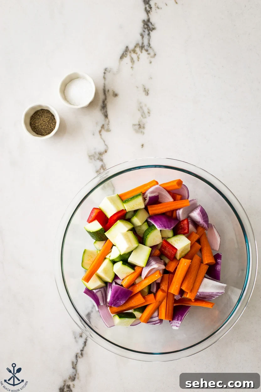 Roasted Vegetable Couscous Recipe 4 Overhead photo of a bowl filled with vegetables and two small bowls of salt and pepper