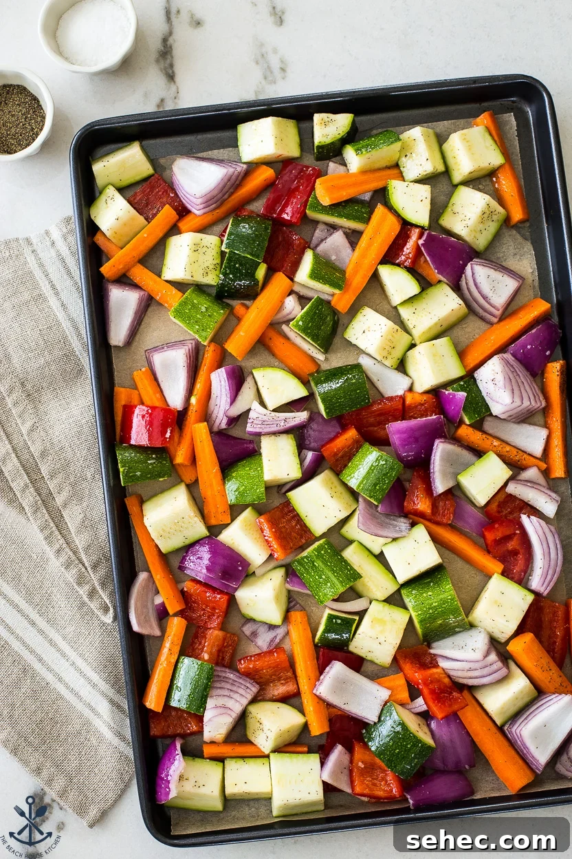 Roasted Vegetable Couscous Recipe 5 Overhead photo of a sheet pan of pre-cooked vegetable chunks
