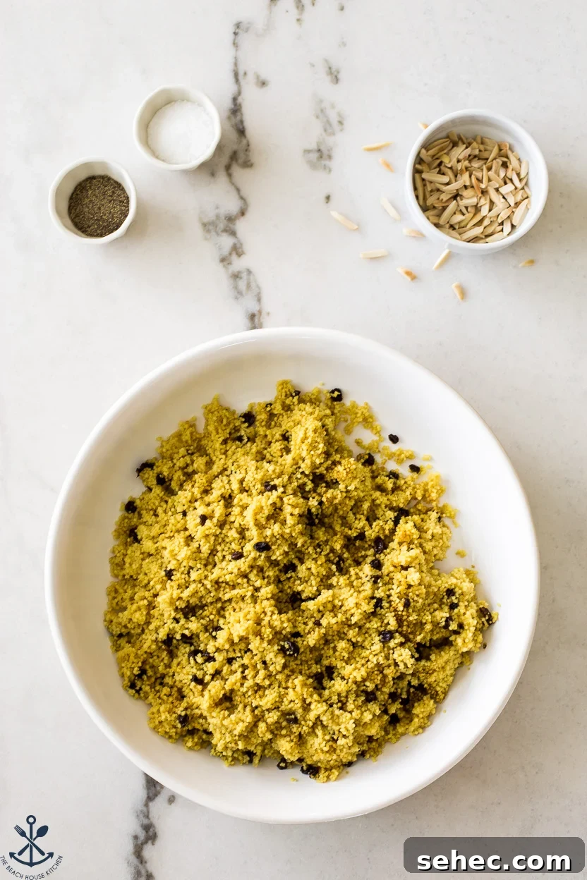 Roasted Vegetable Couscous Recipe 8 Overhead photo of a round dish of cooked couscous and currants