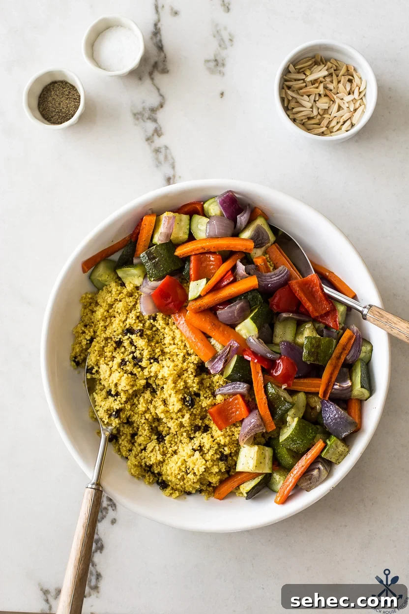 Roasted Vegetable Couscous Recipe 9 Overhead photo of a round dish of cooked couscous and roasted vegetables