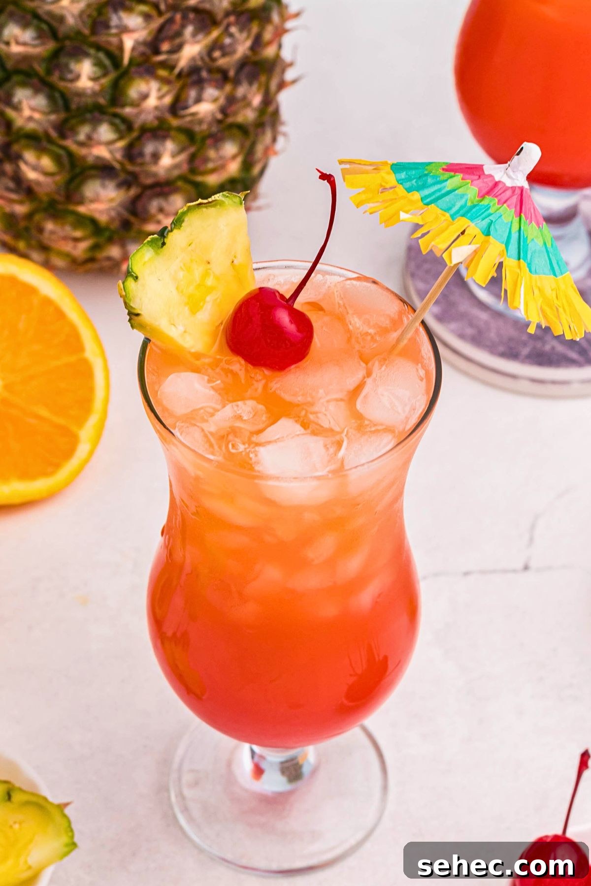 Bahama Mama Cocktail Recipe 7 Finished Bahama Mama cocktail with a cherry, pineapple slice, and paper umbrella.