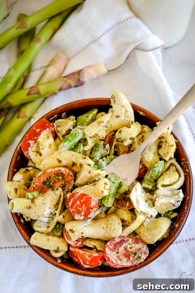 Creamy Pesto Pasta Salad with Fresh Basil 6 Serving dish of creamy pesto pasta salad drizzled with dressing