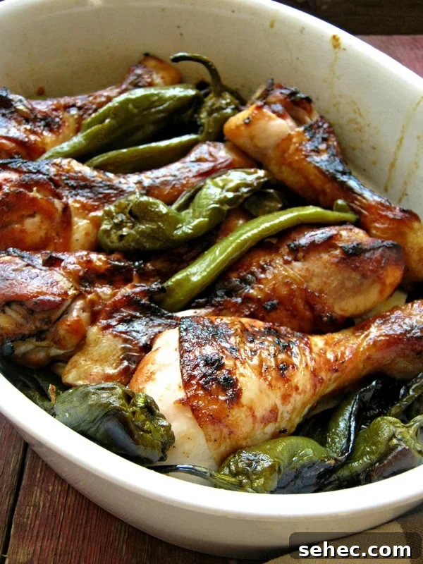 Italian Oven Roasted Green Peppers Recipe 8 drumsticks with peppers in a white serving dish