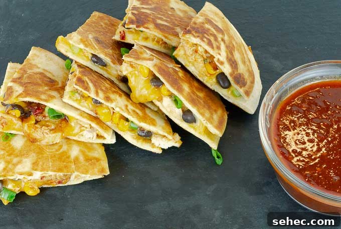 Chipotle BBQ Chicken Quesadillas 3 quartered Chipotle Barbecue Sauce Chicken Quesadillas on black slate
