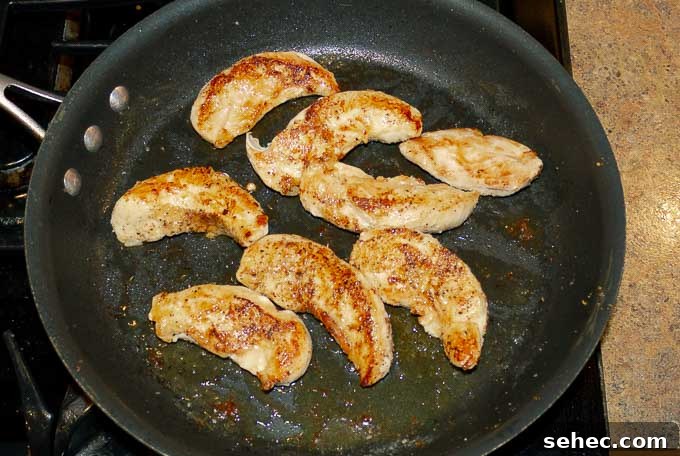 Chipotle BBQ Chicken Quesadillas 5 chicken tenderloins being seared in hot skillet