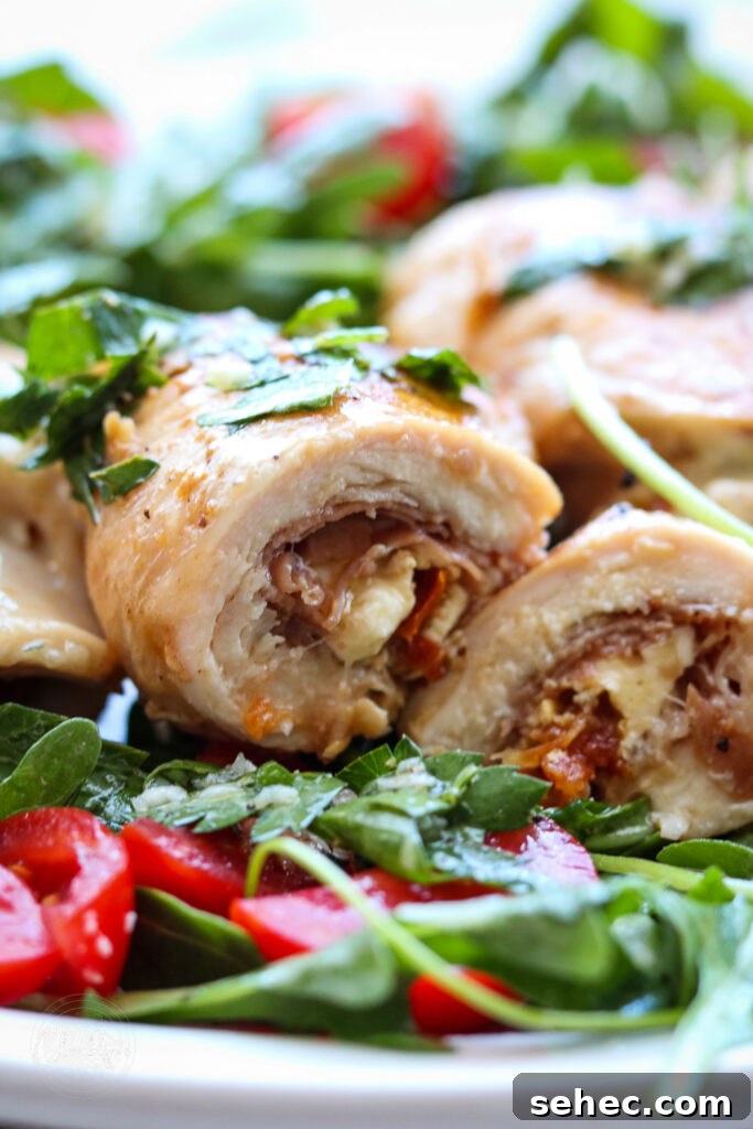 Grilled Chicken Involtini with Prosciutto 10 horizontal photo of grilled chicken involtini sliced in half with arugula salad