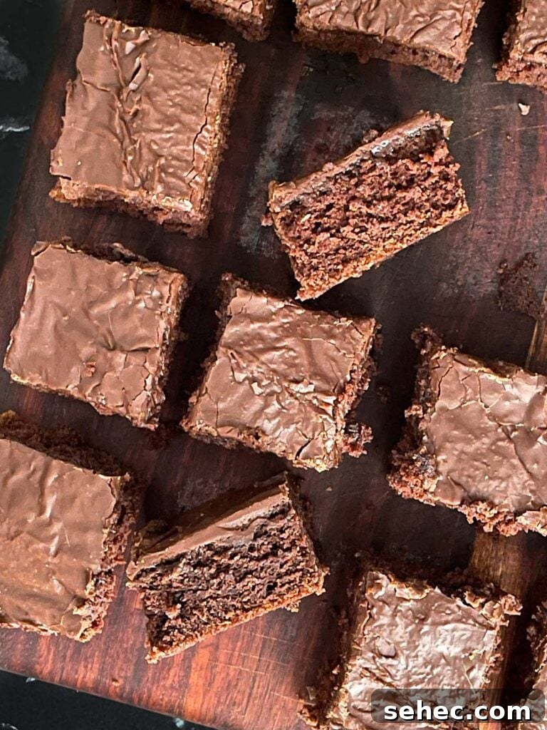 Sliced buttermilk brownies on a wooden cutting board.