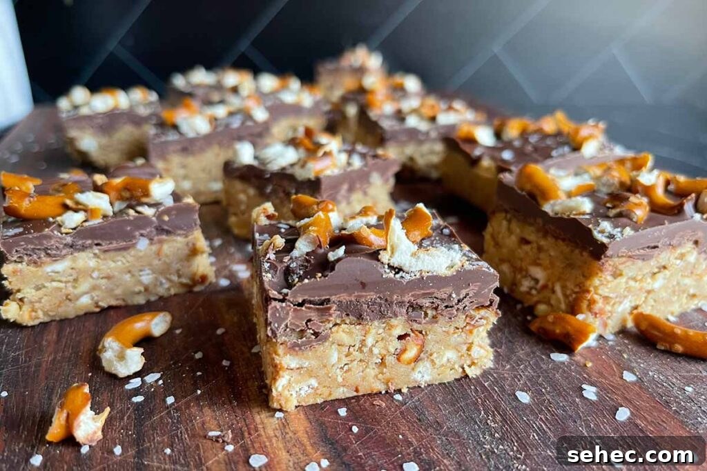 Peanut butter pretzel bars on a dark wooden board.