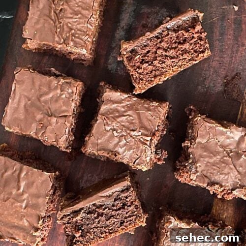 Sliced buttermilk brownies on a wooden cutting board.