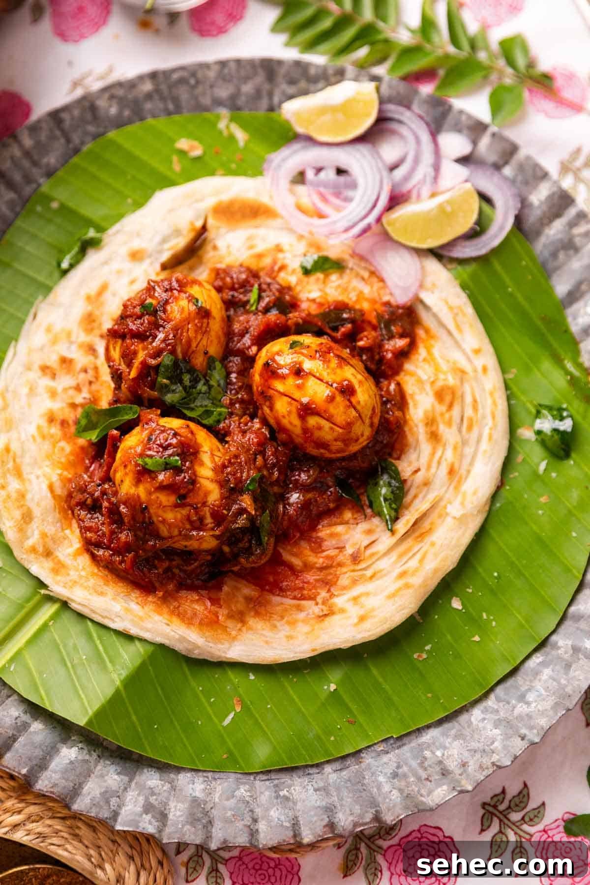 Kerala Egg Roast Mutta Roast Recipe 2 Kerala egg roast served on Malabar Parotta with accompaniments