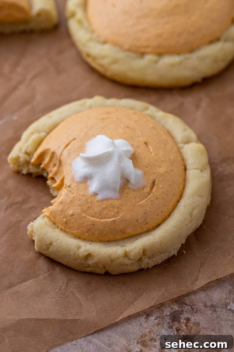40 Crumbl Cookie Copycat Recipes to Try in 2025 25 Crumbl pumpkin pie cookie with a bite taken out of it