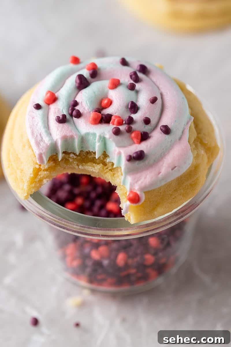 40 Crumbl Cookie Copycat Recipes to Try in 2025 33 Crumbl Cotton candy cookie with a bite taken out of it