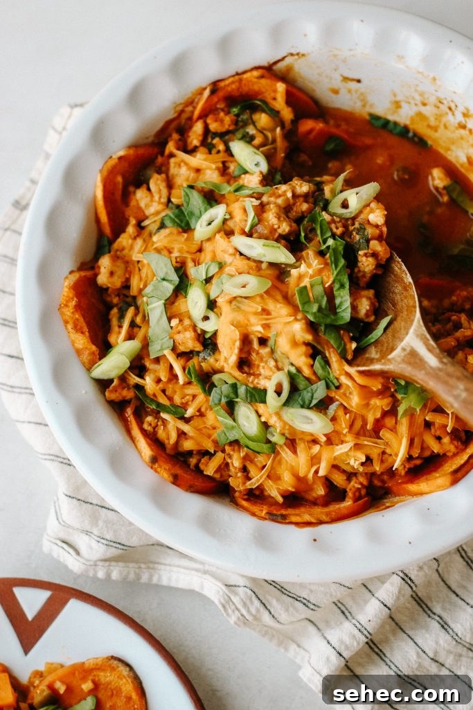 Sweet Potato Enchilada Casserole Recipe 3 Healthy enchilada sweet potato casserole in a baking dish with a wooden spoon