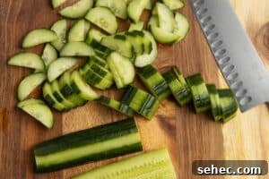 Crunchy Cucumber Carrot Salad Recipe 11 This is a picture of cucumber being sliced.