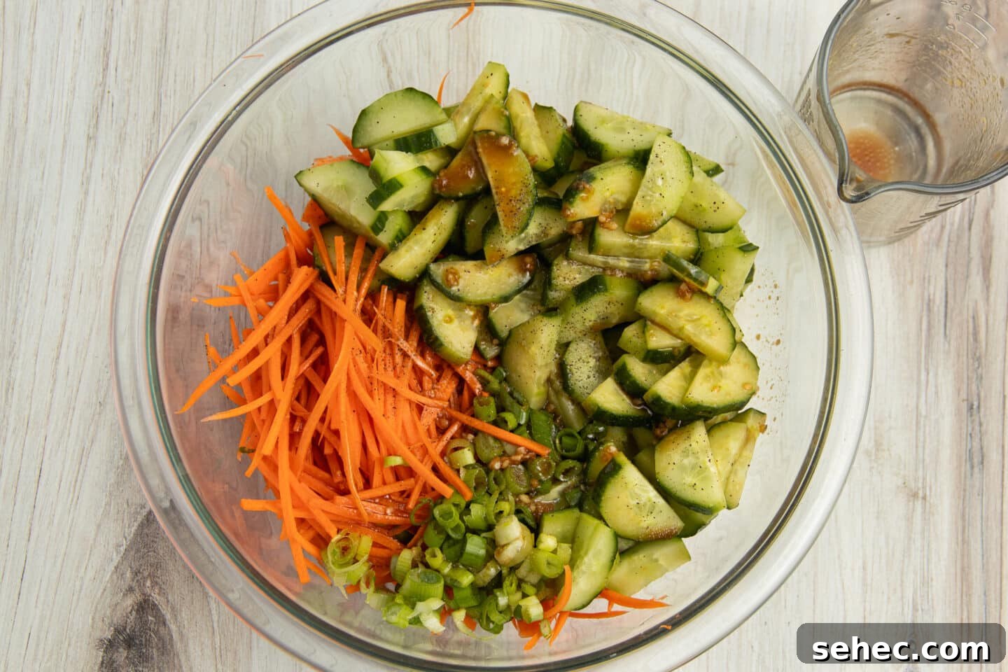 Crunchy Cucumber Carrot Salad Recipe 7 This is a picture of all the veggies and dressing together in a bowl.