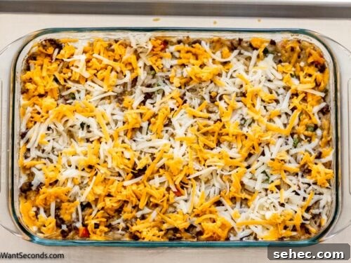 Cheesy Hamburger Hash Brown Casserole Recipe 7 Step 6 how to make hamburger hashbrown casserole with frozen hashbrown, Remove from the oven and add the remaining cheese. Bake again until the cheese melts.