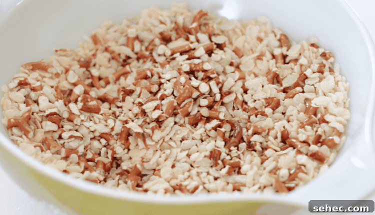 Pretzel Scotcheroos Recipe with Video 7 chopped pretzels and cereal in a large bowl