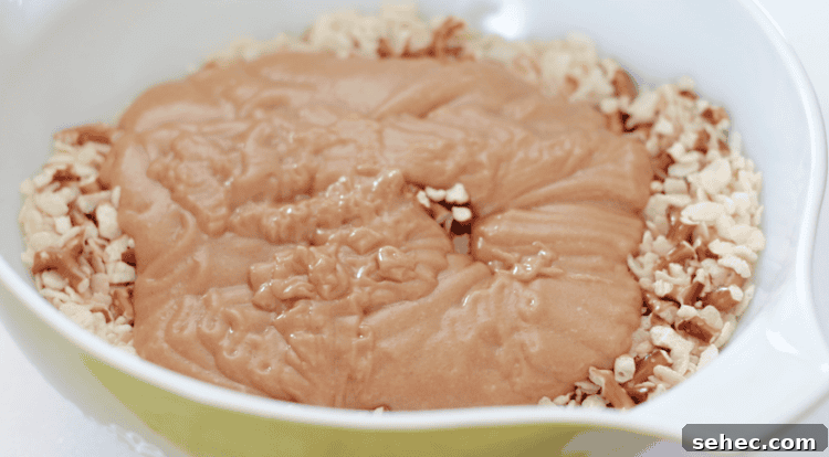 Pretzel Scotcheroos Recipe with Video 8 bowl of chopped pretzels, cereal and peanut butter sauce