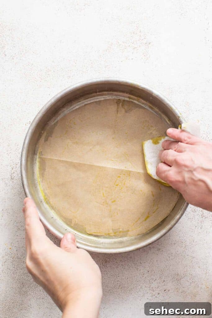 Moist French Apple Cake Without Rum 4 Greasing a cake pan with butter.