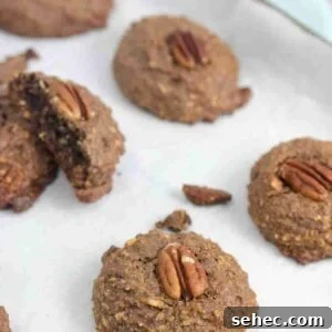 High Protein Cookies for Pregnancy 9 Chocolate pregnancy cookies with pecans on top on a baking sheet with parchment paper.