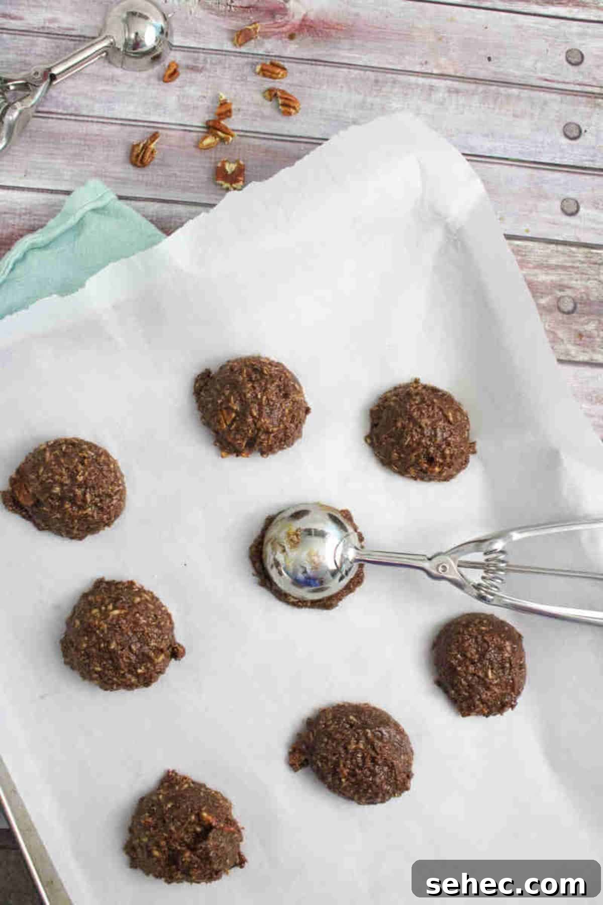 High Protein Cookies for Pregnancy 6 Raw pregnancy cookies on a baking sheet with a trigger ice cream scoop on it.