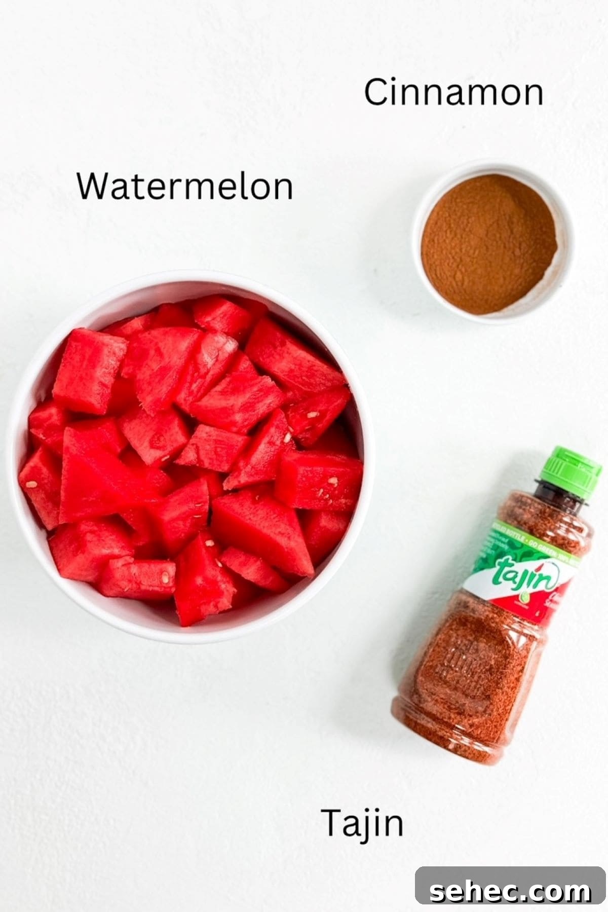 5 Minute Tajin Watermelon Snack 3 Watermelon in a bowl, cinnamon in a small bowl, and a bottle of Tajin.